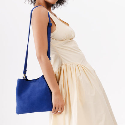Joni Blue | symmetrical bucket bag with latch closure and removable crossbody strap