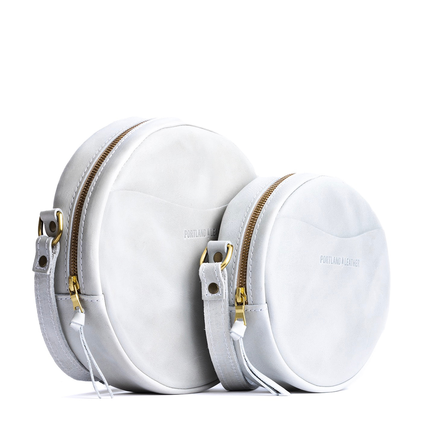 Beluga | Size comparison image of small and large circle shaped crossbody bags with top zipper