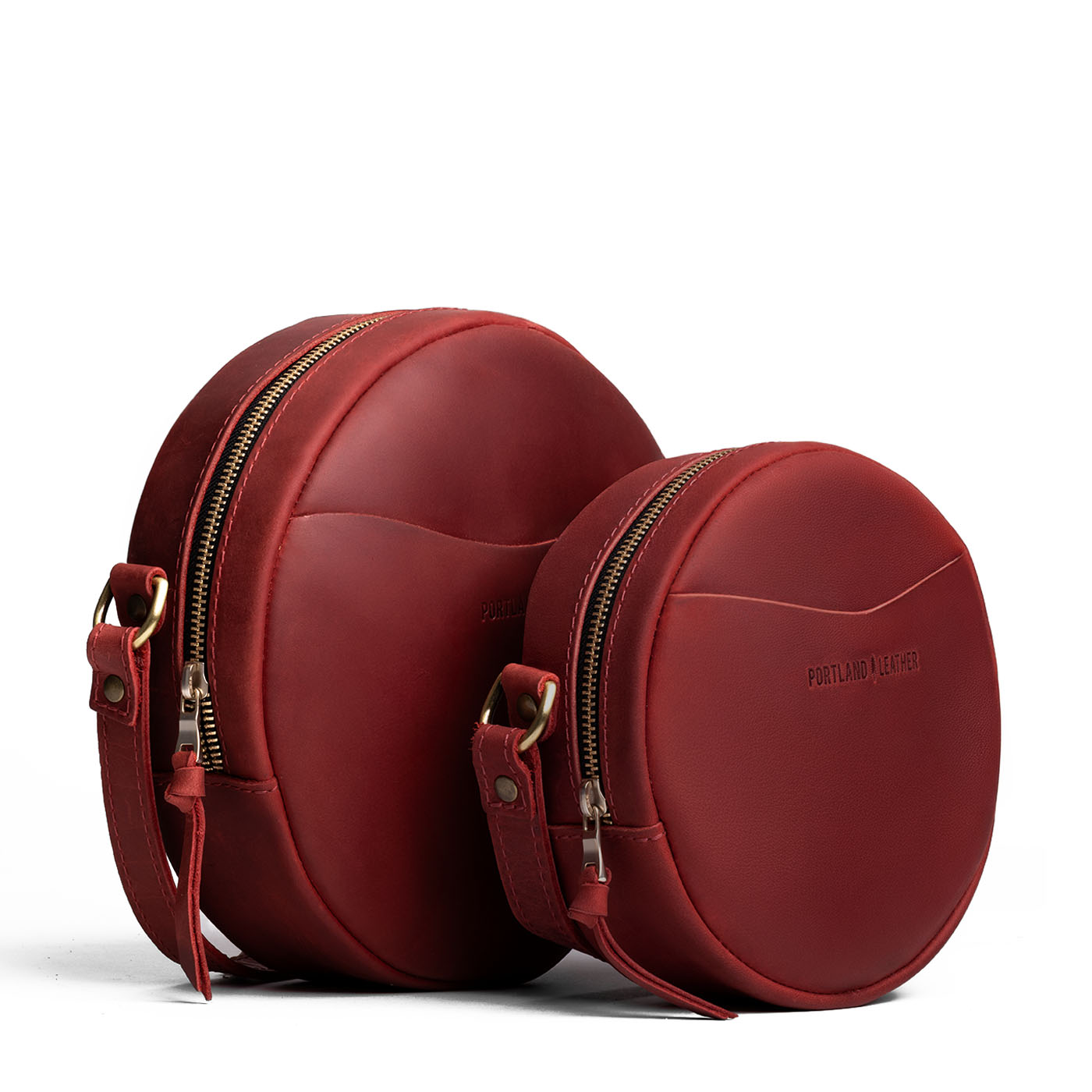 Phoenix | Size comparison image of small and large circle shaped crossbody bags with top zipper