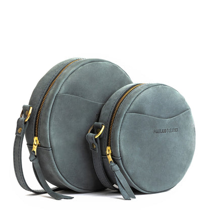 Storm | Size comparison image of small and large circle shaped crossbody bags with top zipper