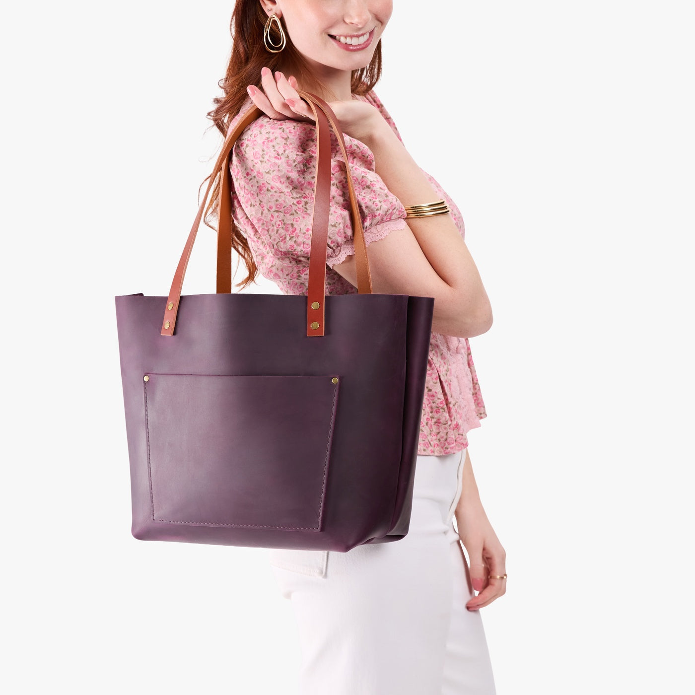 Larkspur*Classic | Model holding large leather tote bag with sturdy bridle handles and front pocket