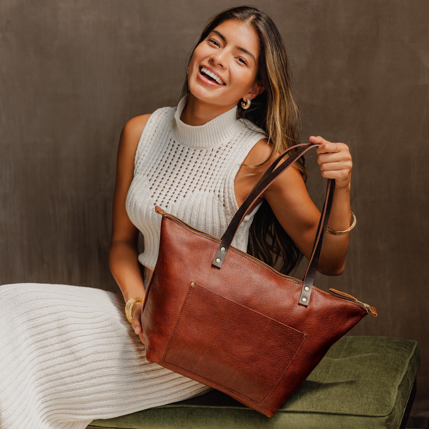 Nutmeg*Zipper | Model holding large zipper leather tote bag with sturdy bridle handles and front pocket