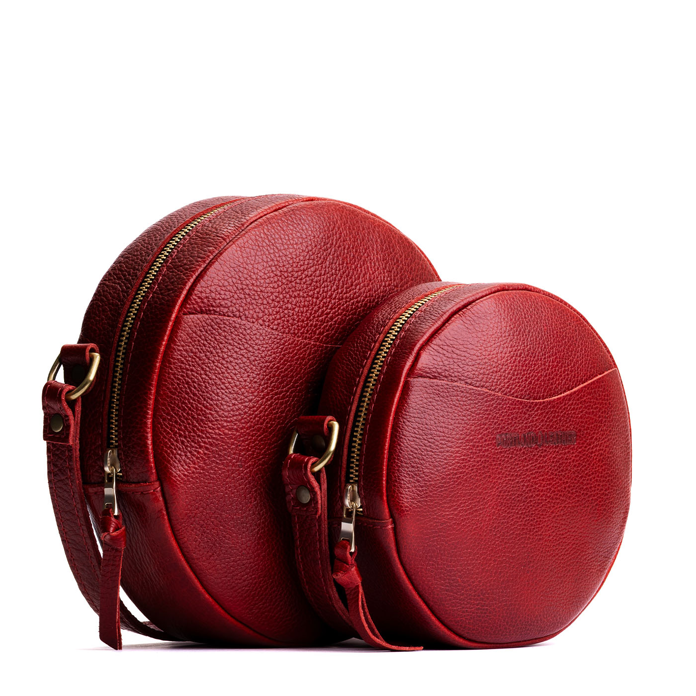 Chili Red | Size comparison image of small and large circle shaped crossbody bags with top zipper