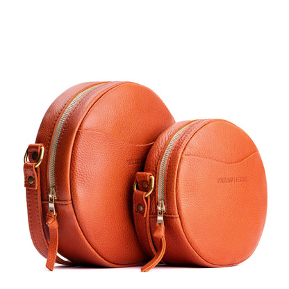 Koi | Size comparison image of small and large circle shaped crossbody bags with top zipper