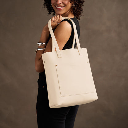 Pebbled Bone*Classic | Model holding medium Tote with dual shoulder straps and crossbody strap