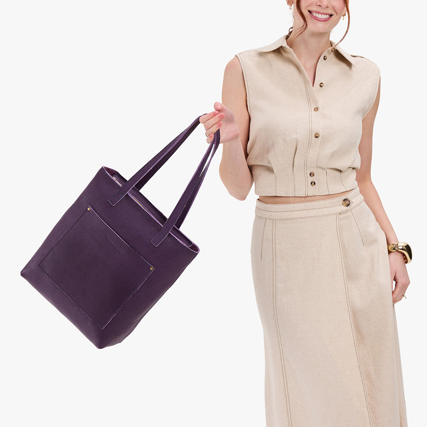 Empire*Zipper | Model holding medium Tote with dual shoulder straps and crossbody strap