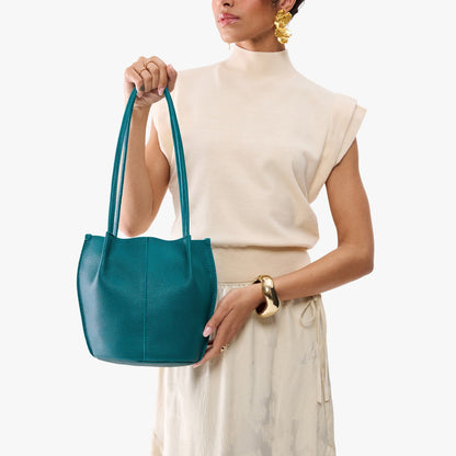 Aquarius*Small | Model wearing matching white shirt and skirt carrying petite bucket shaped tote bag with matching leather handles