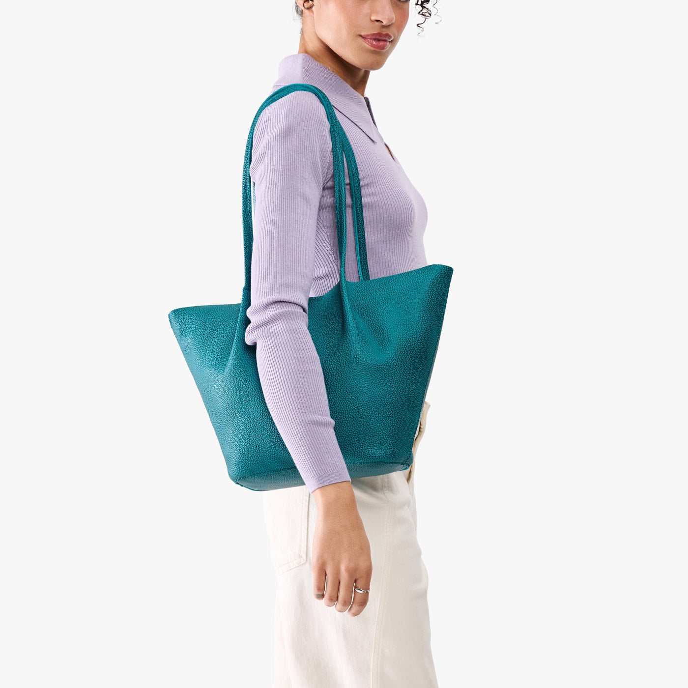 Aquarius*Large | Model wearing lavender sweater and white pants carrying wide bucket shaped tote bag with matching leather handles
