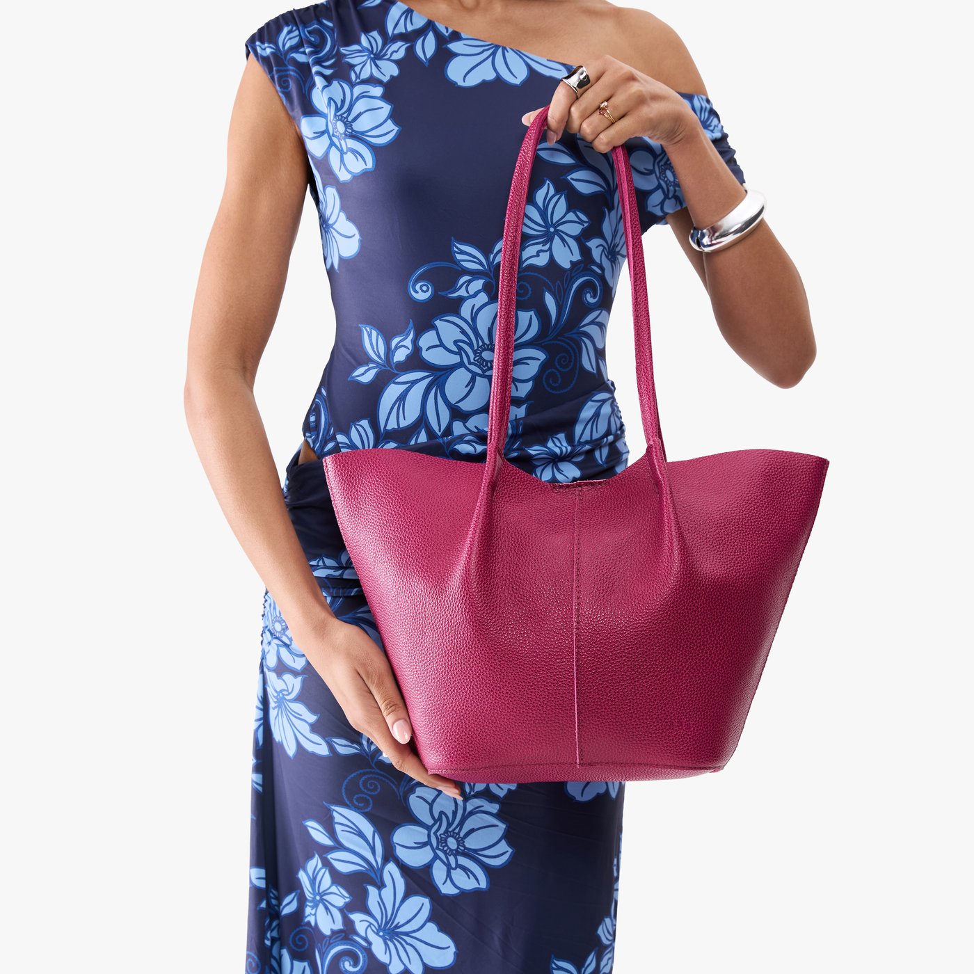 Cosmo*Large | Model wearing blue floral patterned dress holding wide bucket shaped tote bag with matching leather handles