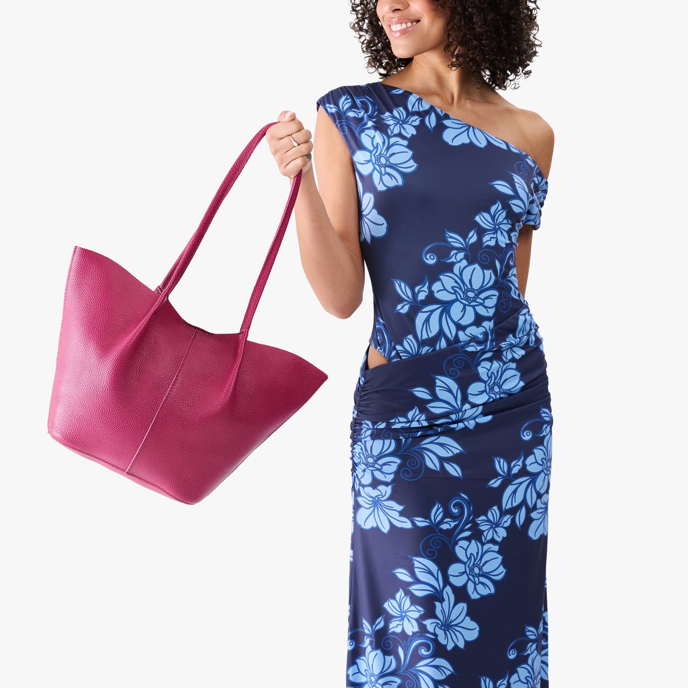 Cosmo*Large | Model wearing blue floral patterned dress holding wide bucket shaped tote bag with matching leather handles