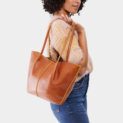Sienna*Large | Model holding wide bucket shaped tote bag with matching leather handles