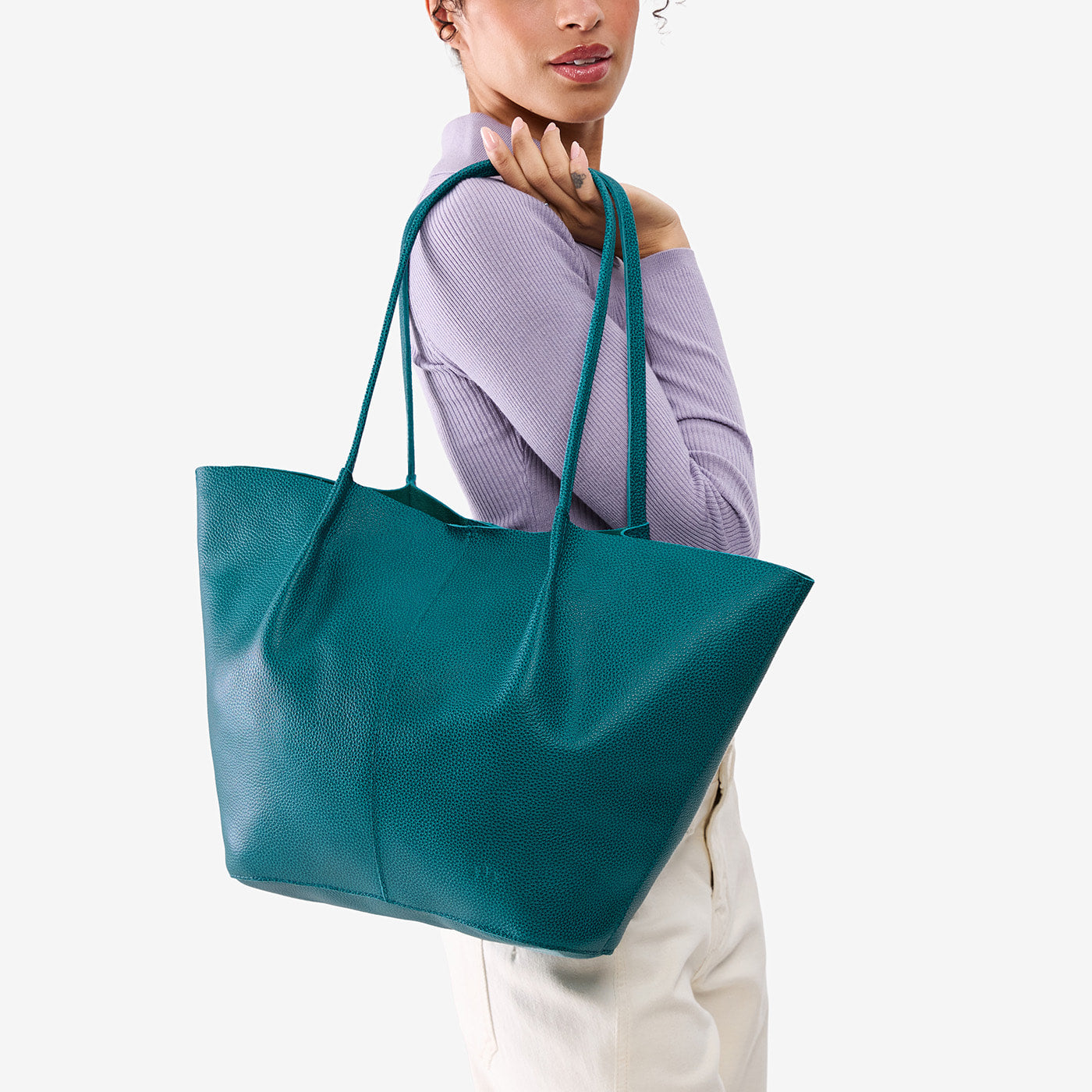 Aquarius*Oversized | Model carrying extra wide bucket shaped tote bag with matching leather handles