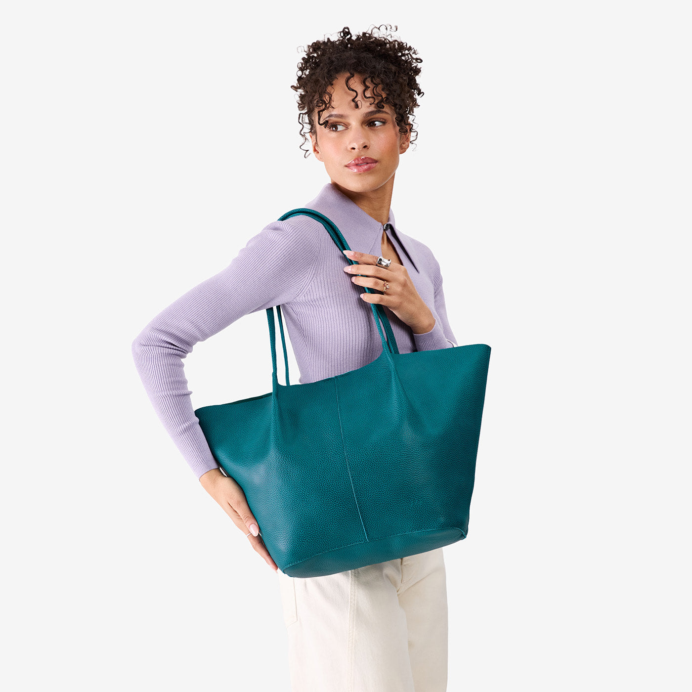 Aquarius*Oversized | Model carrying extra wide bucket shaped tote bag with matching leather handles
