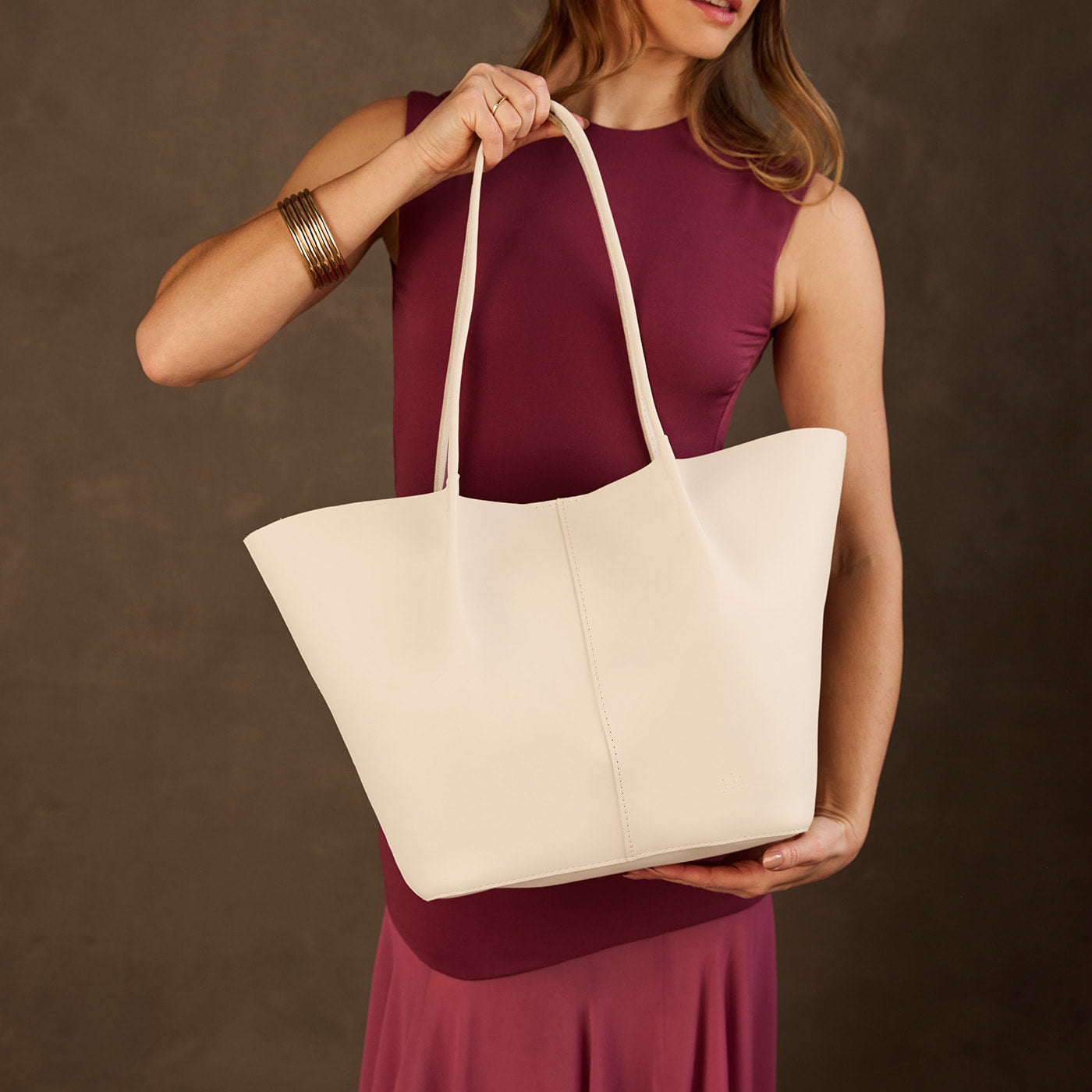 Bone*Oversized | Model holding extra wide bucket shaped tote bag with matching leather handles
