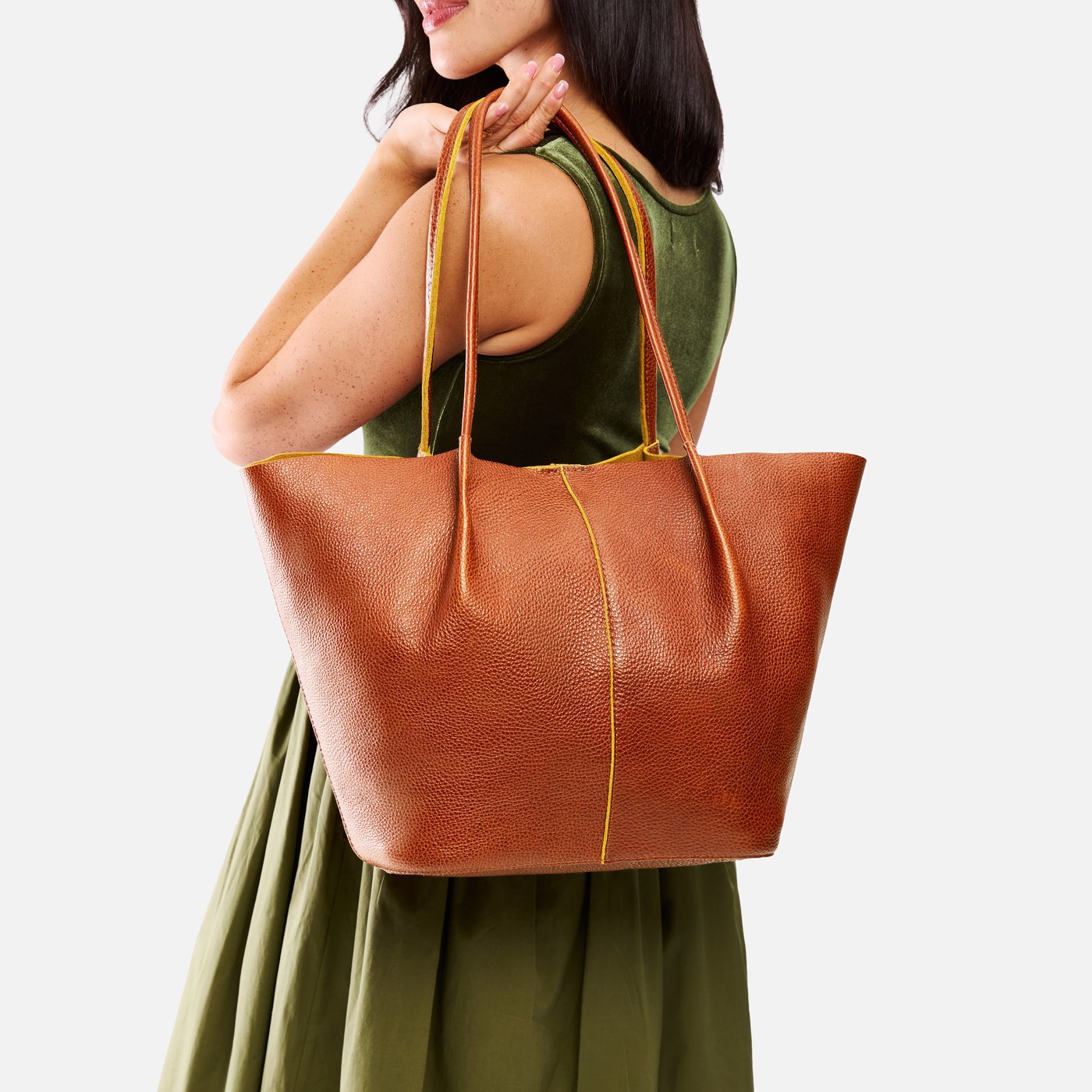 Sienna*Oversized | Model holding extra wide bucket shaped tote bag with matching leather handles