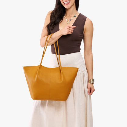 Sunshine*Oversized | Model wearing brown sleeveless top with white skirt carrying extra wide bucket shaped tote bag with matching leather handles