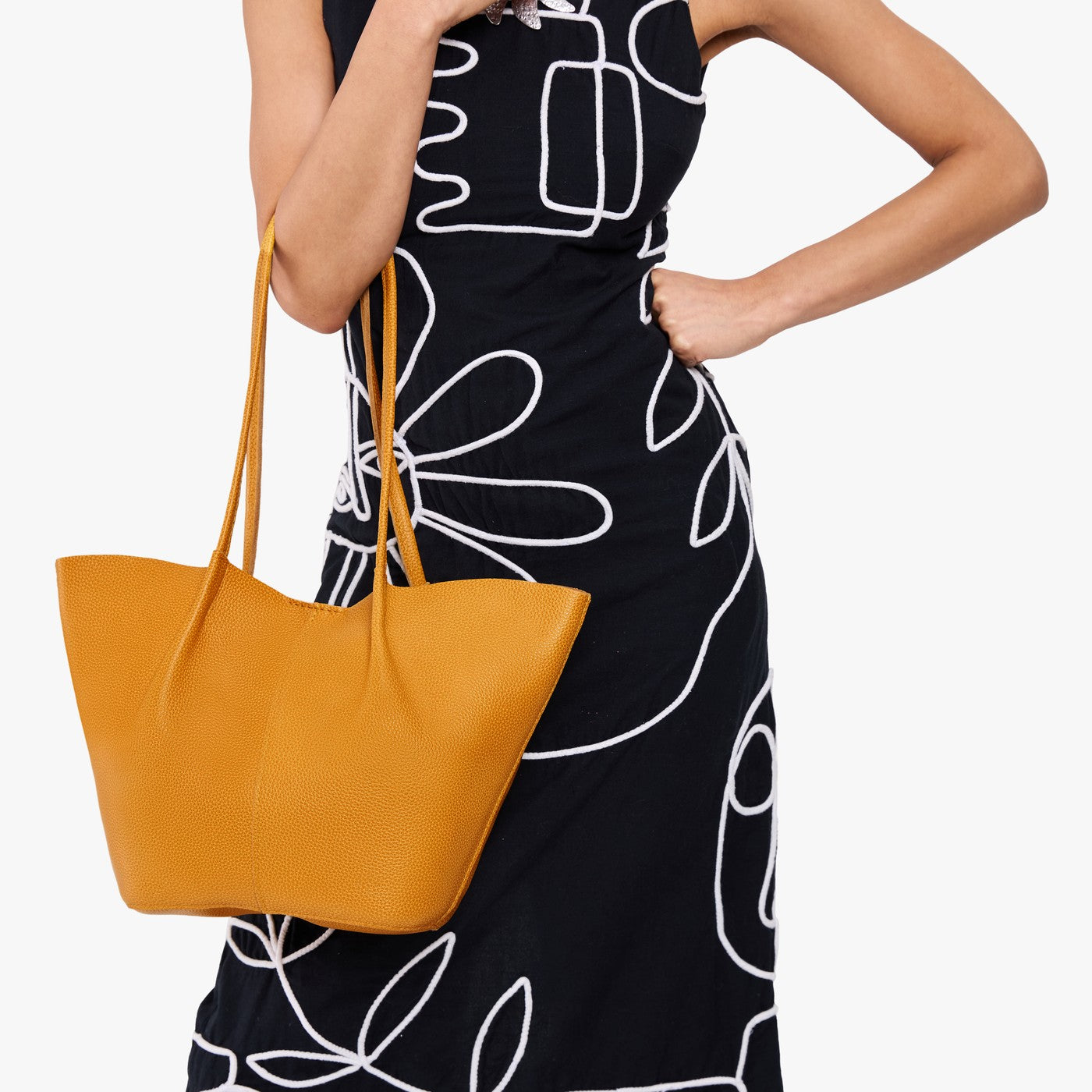 Sunshine*Large | Model wearing black dress and carrying wide bucket shaped tote bag with matching leather handles