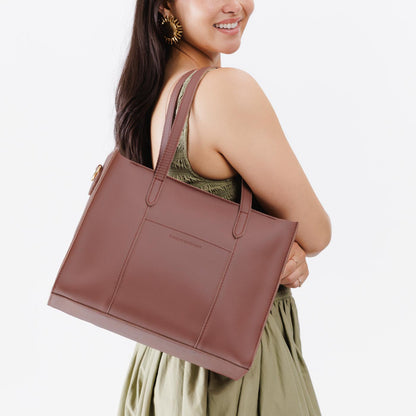 Sunkissed*East/West | Model wearing structured wide tote bag with overlapping panels and crossbody strap
