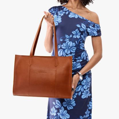 Honey*Oversized East/West | Model holding structured wide tote bag with overlapping panels and crossbody strap
