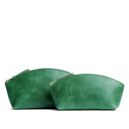 Cowboy Mint | Size comparison shot of two spacious leather makeup bags with curved seams and top zipper