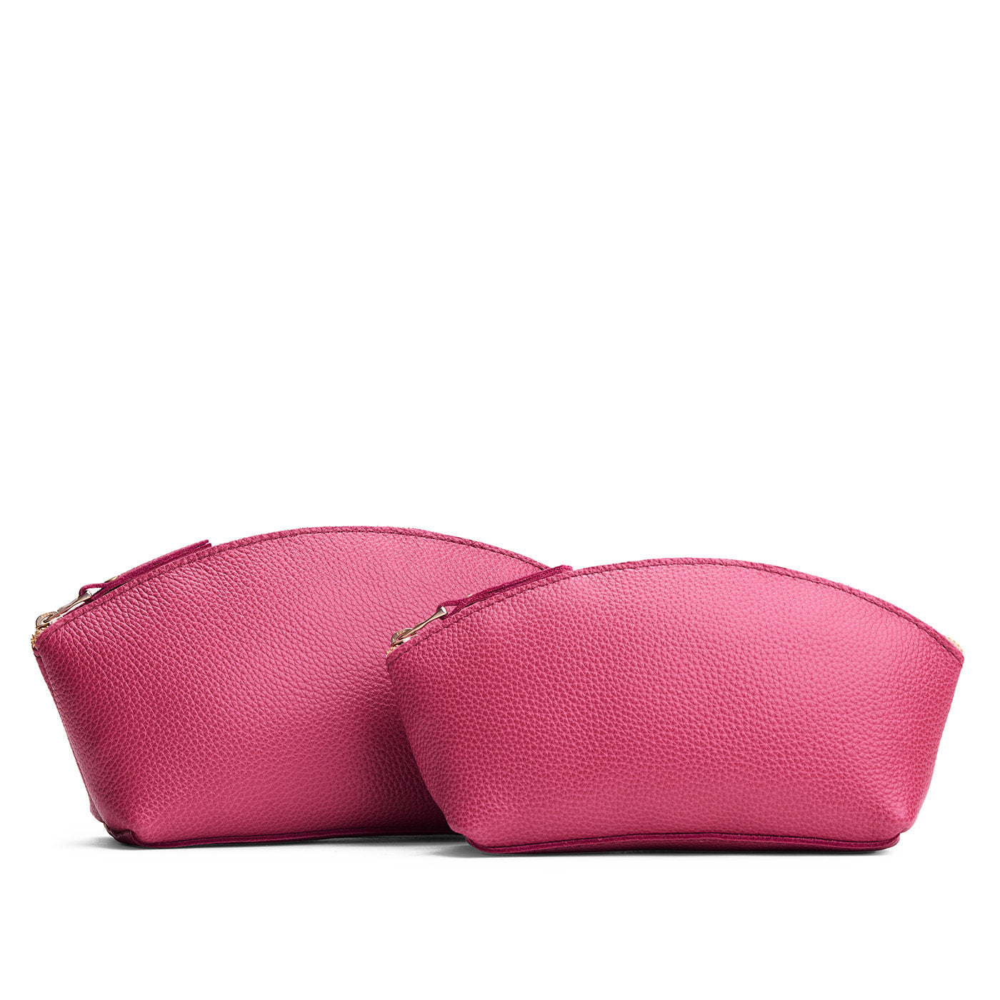 Wild Rose | Size comparison shot of two spacious leather makeup bags with curved seams and top zipper