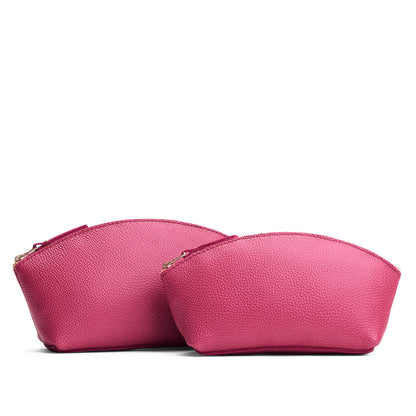 Wild Rose | Size comparison shot of two spacious leather makeup bags with curved seams and top zipper