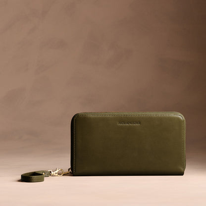 Bay Green | Full zip around wallet with a strap on a brown background