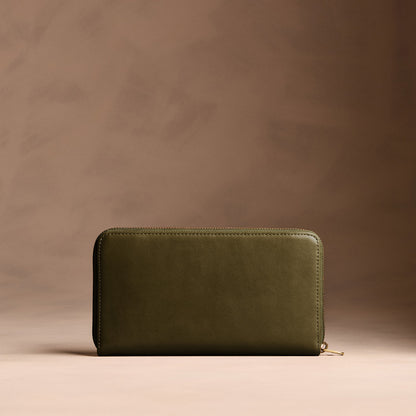 Bay Green | Full zip around wallet with a strap on a brown background