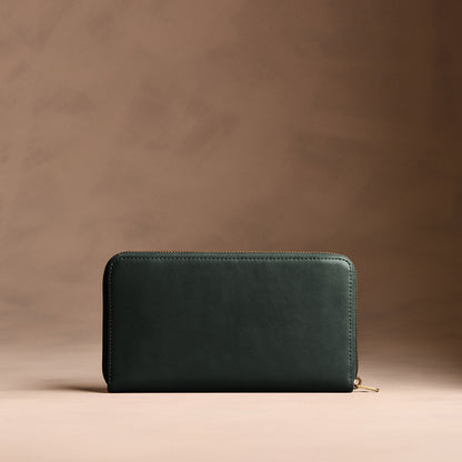 Regent Green | Full zip around wallet with a strap on a brown background
