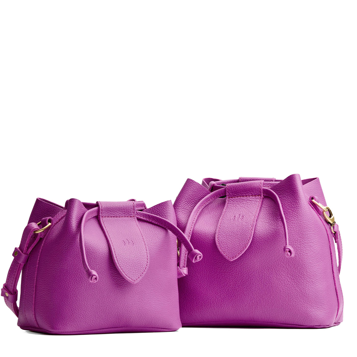 Cattleya | Small and large symmetrical leather bags with leather drawstring closure and adjustable shoulder strap
