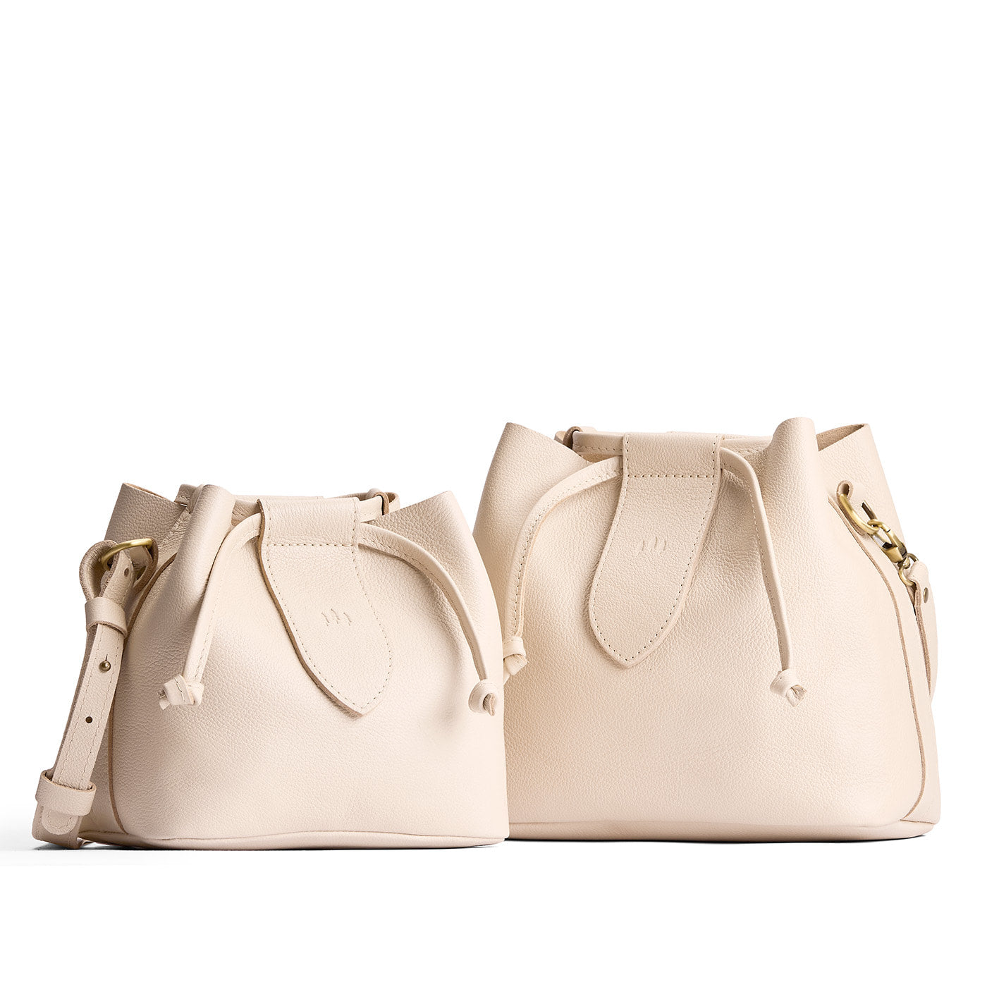 Pebbled Bone | Small and large symmetrical leather bags with leather drawstring closure and adjustable shoulder strap