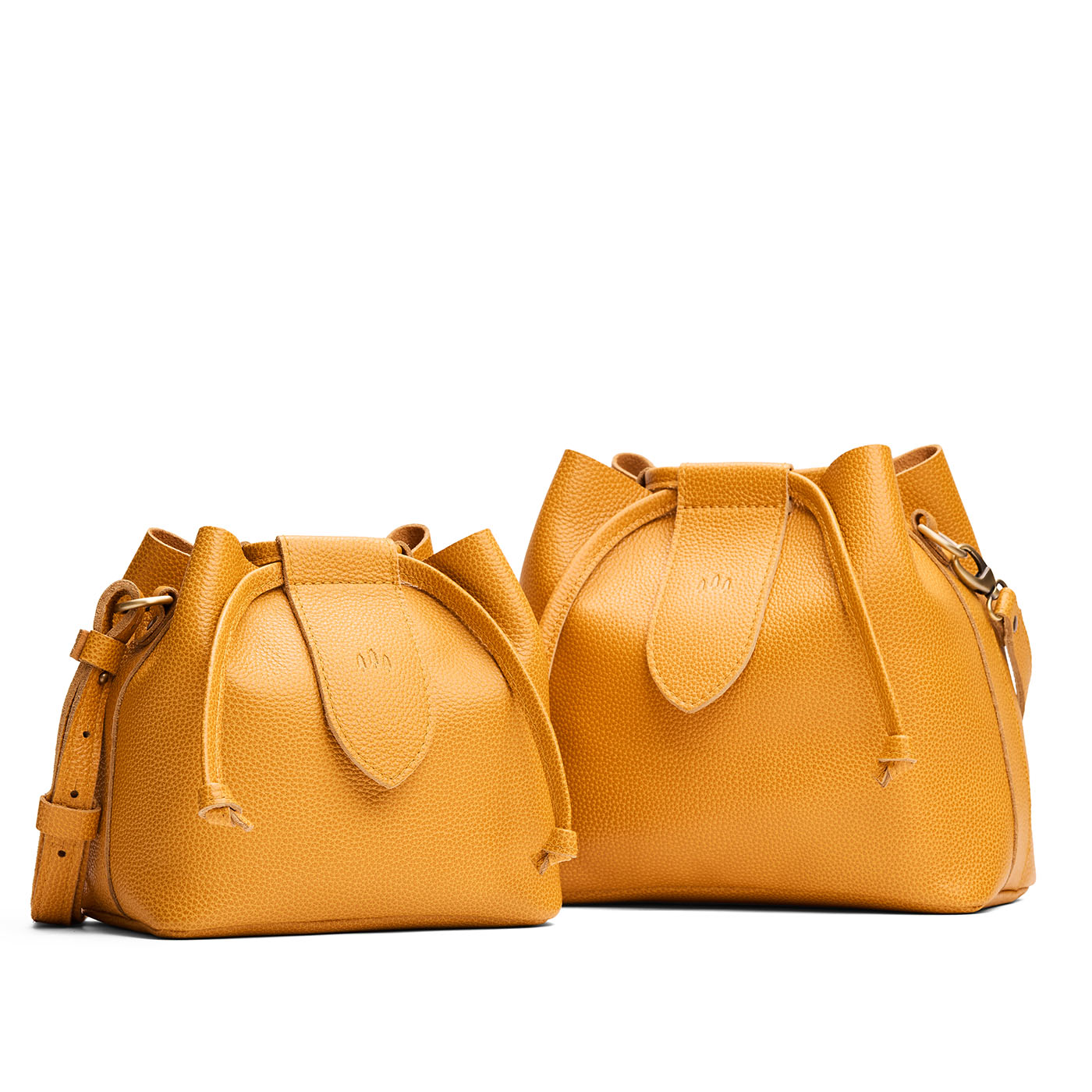 Sunshine | Small and large symmetrical leather bags with leather drawstring closure and adjustable shoulder strap