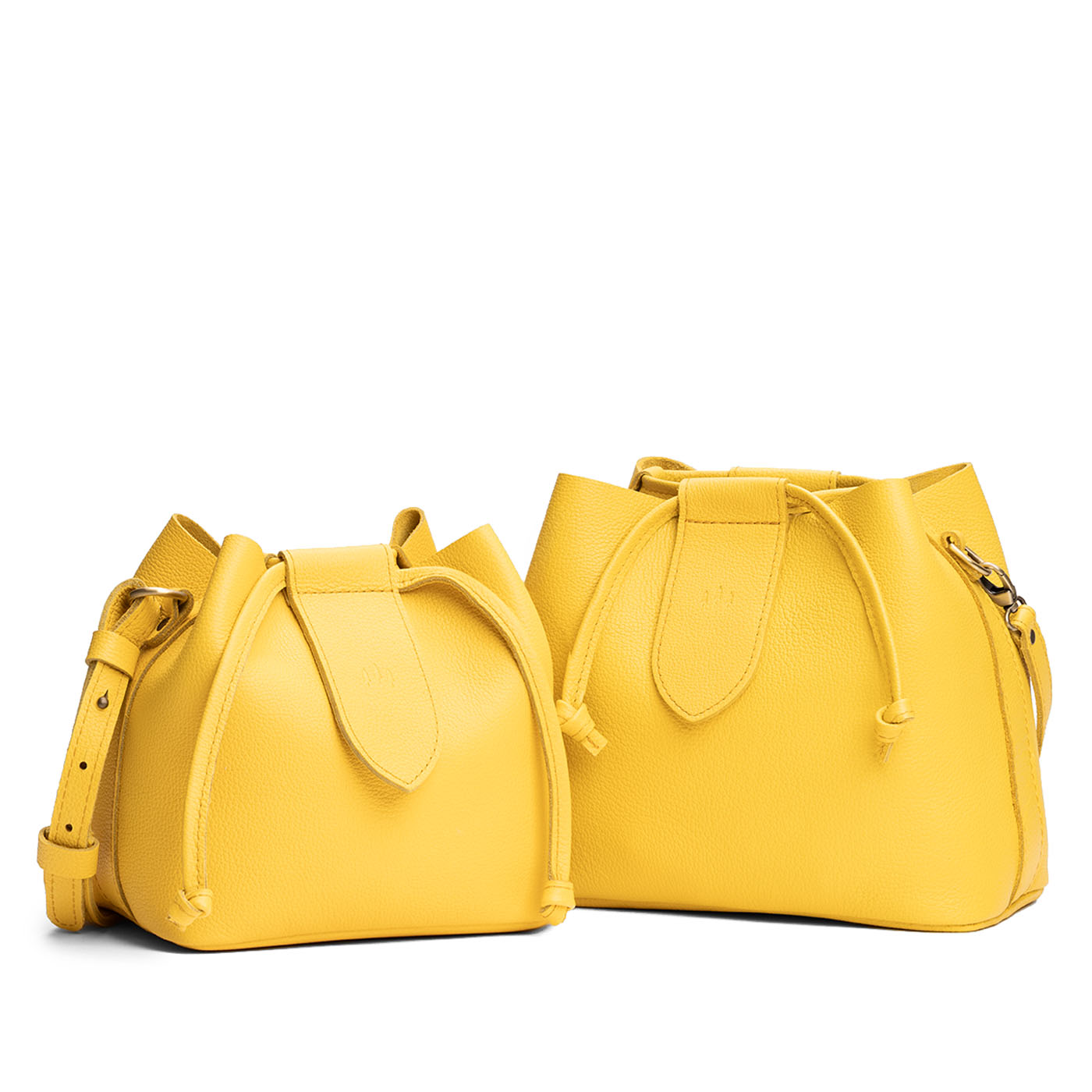 Canary | Small and large symmetrical leather bags with leather drawstring closure and adjustable shoulder strap