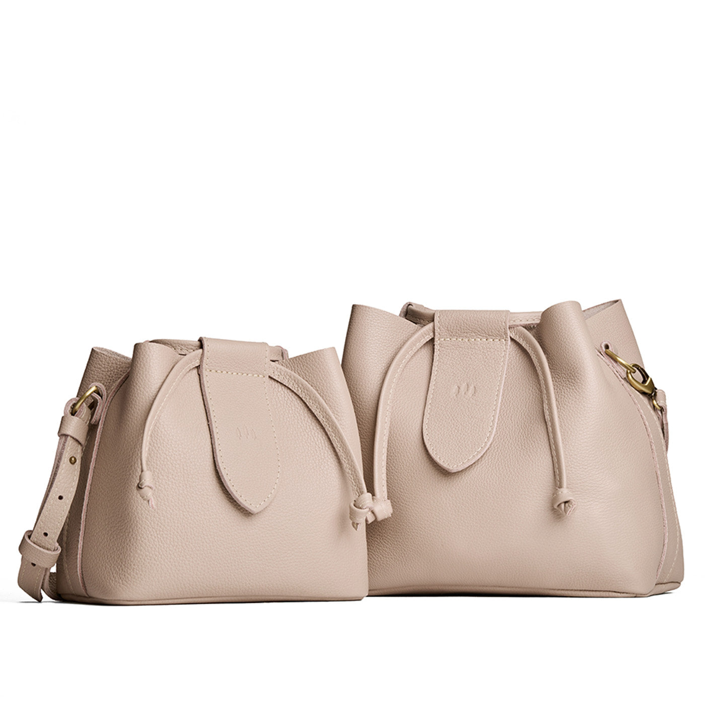 Oatmilk | Small and large symmetrical leather bags with leather drawstring closure and adjustable shoulder strap