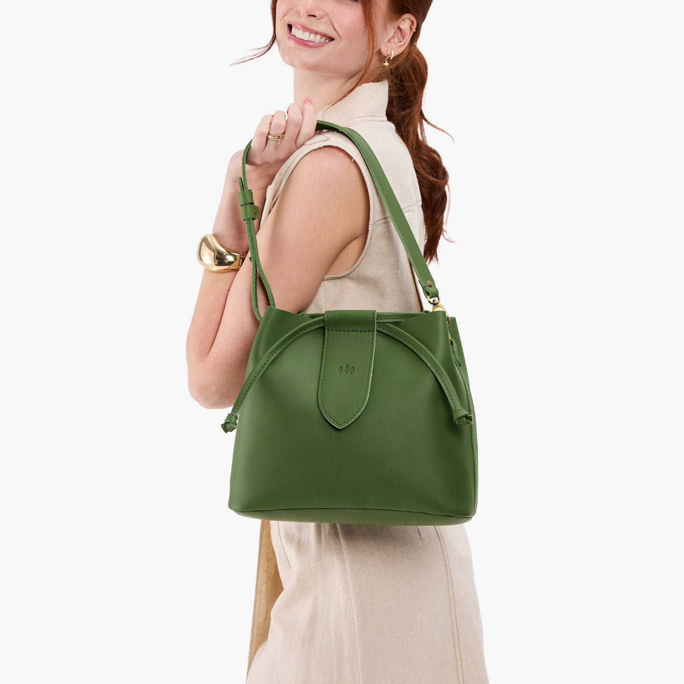 Cactus*Large | Model holding symmetrical leather bag with leather drawstring closure and adjustable shoulder strap