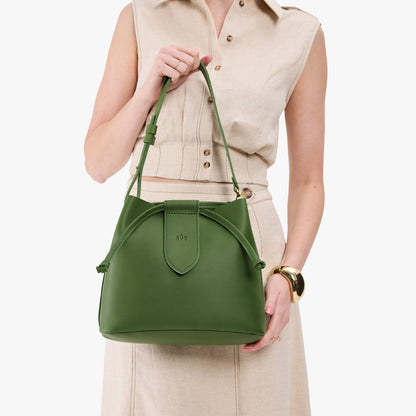 Cactus*Large | Model holding symmetrical leather bag with leather drawstring closure and adjustable shoulder strap