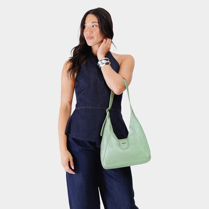 Beetle | Model wearing structured hobo shoulder bag with adjustable strap and magnetic closure