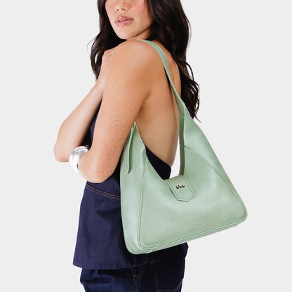 Beetle | Model wearing structured hobo shoulder bag with adjustable strap and magnetic closure