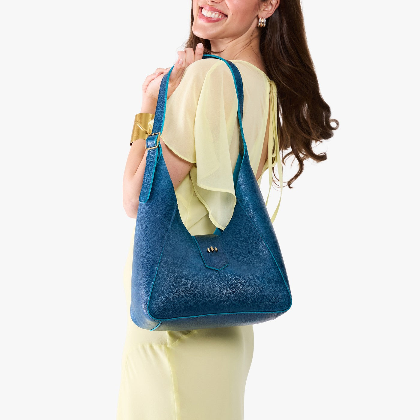 Caspian | Model wearing a structured hobo shoulder bag with adjustable strap and magnetic closure