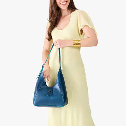 Caspian | Model wearing a structured hobo shoulder bag with adjustable strap and magnetic closure