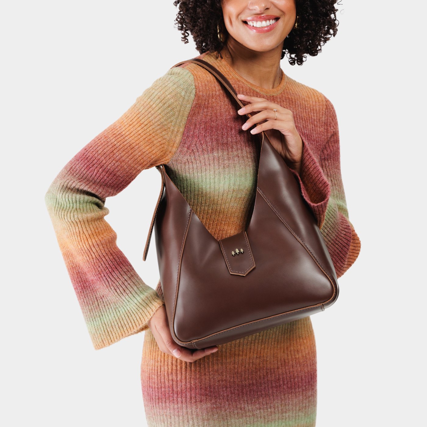 Chocolate Brown | Model wearing structured hobo shoulder bag with adjustable strap and magnetic closure