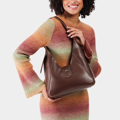 Chocolate Brown | Model wearing structured hobo shoulder bag with adjustable strap and magnetic closure