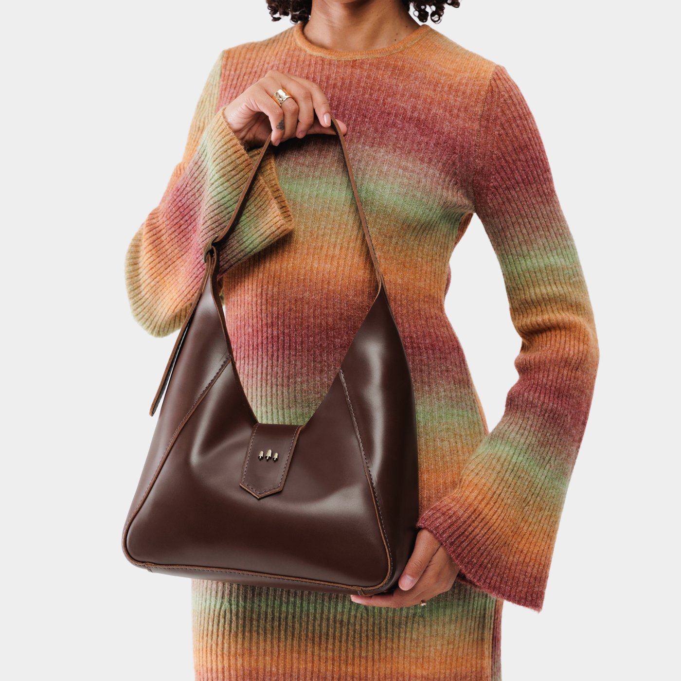 Chocolate Brown | Model wearing structured hobo shoulder bag with adjustable strap and magnetic closure
