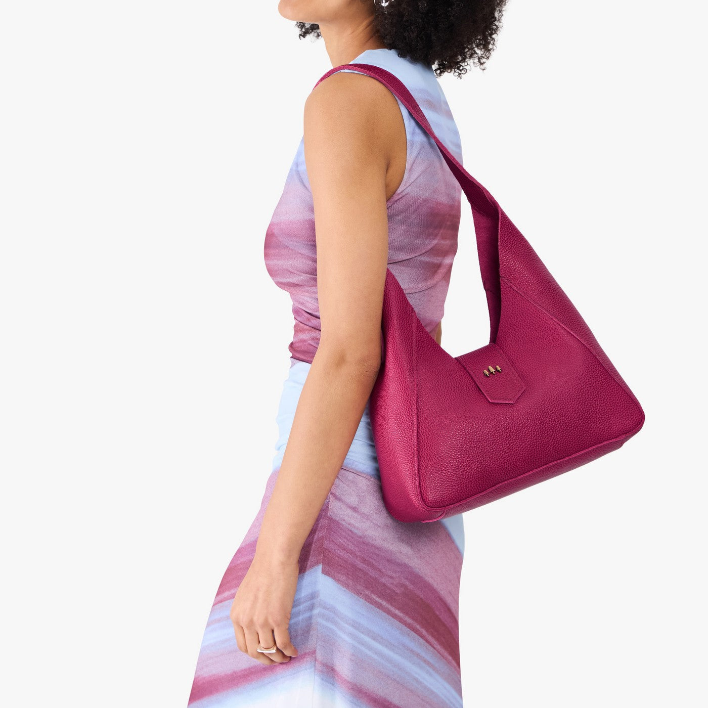 Cosmo | Model wearing structured hobo shoulder bag with adjustable strap and magnetic closure