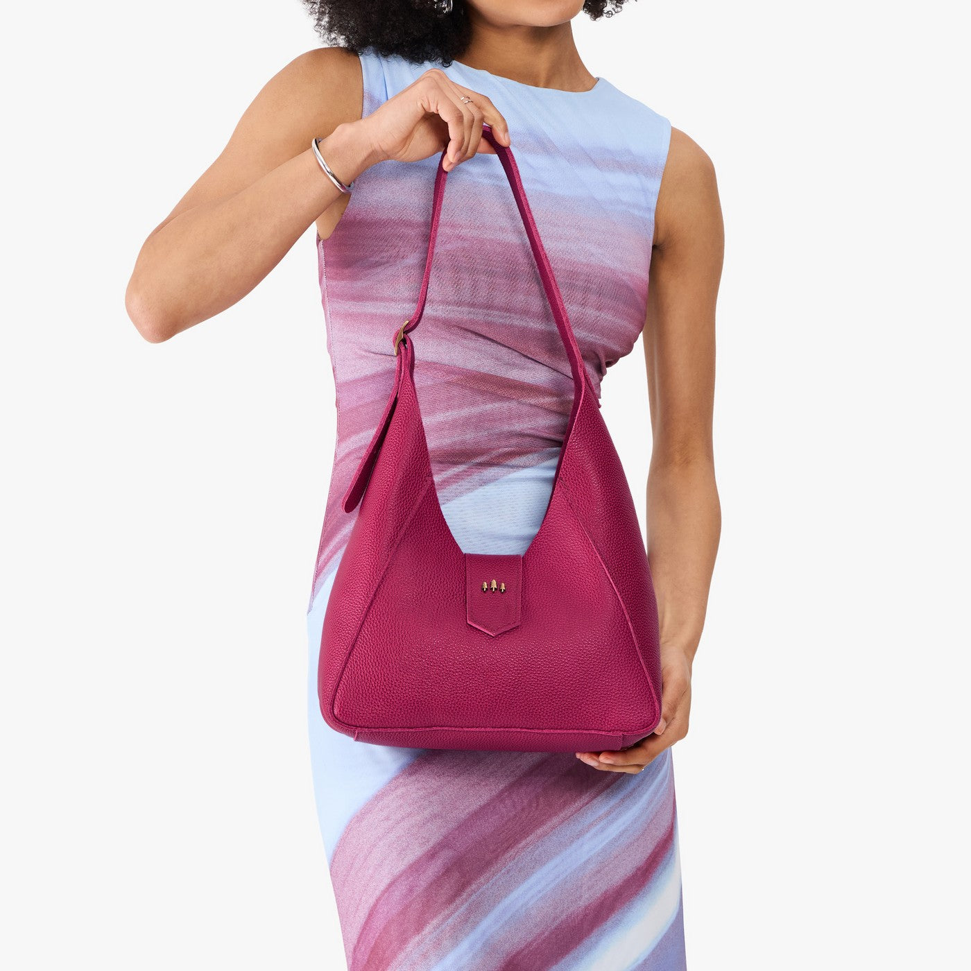 Cosmo | Model wearing structured hobo shoulder bag with adjustable strap and magnetic closure