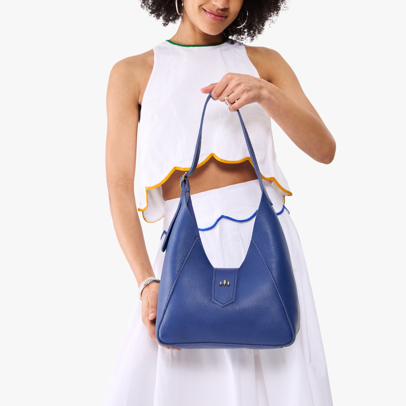 Molino Blue | Model wearing structured hobo shoulder bag with adjustable strap and magnetic closure