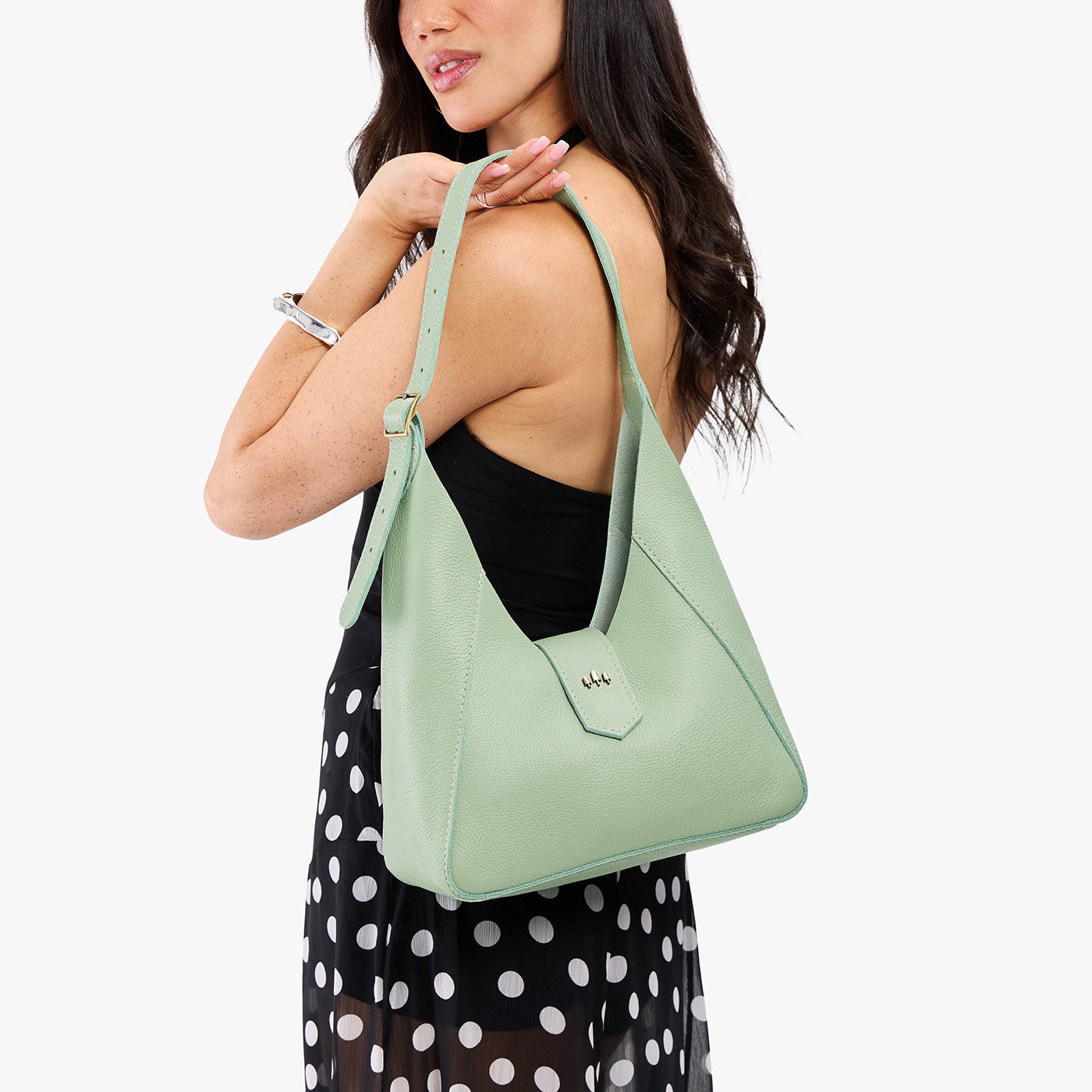 Pistachio | Model wearing structured hobo shoulder bag with adjustable strap and magnetic closure