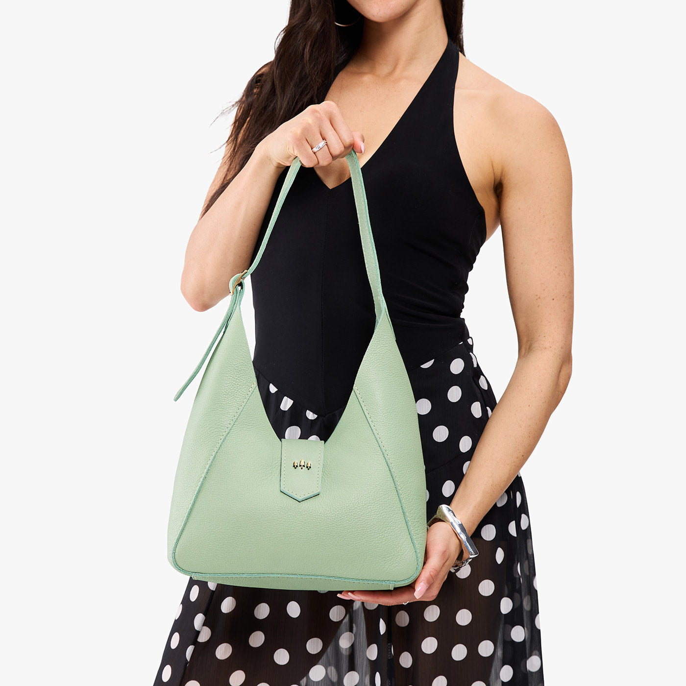 Pistachio | Model wearing structured hobo shoulder bag with adjustable strap and magnetic closure