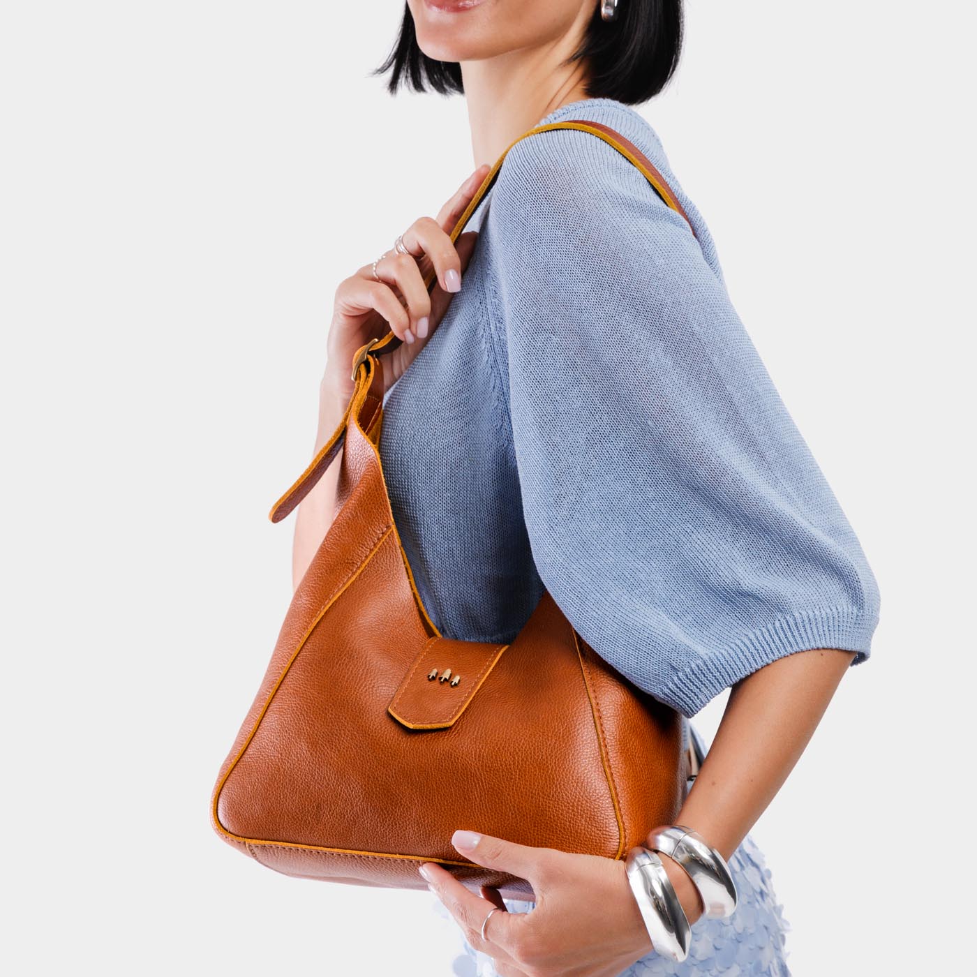 Sienna | Model holding structured hobo shoulder bag with adjustable strap and magnetic closure