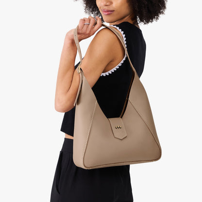 Stone | Model wearing structured hobo shoulder bag with adjustable strap and magnetic closure